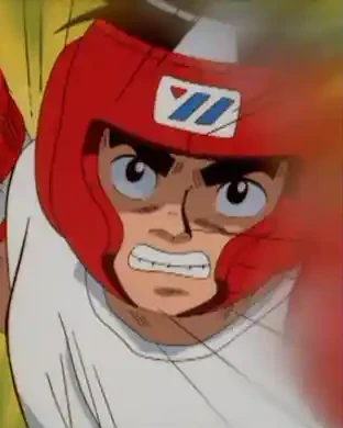 Ippo wears red boxing headgear and raises his gloves.