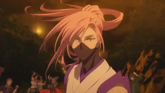 A long-haired skater in glasses and a pale robe stands before a night-time crowd.