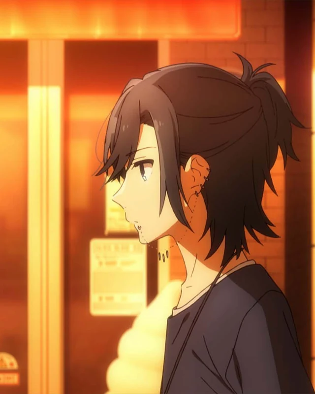 Miyamura wears earrings and casual clothes in warm light.
