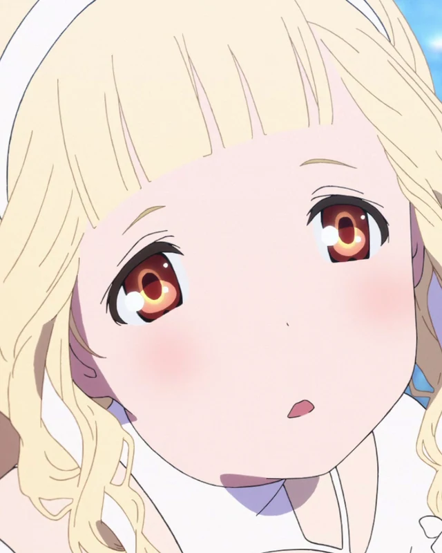 Maquia looks upward against a background of blue flowers.