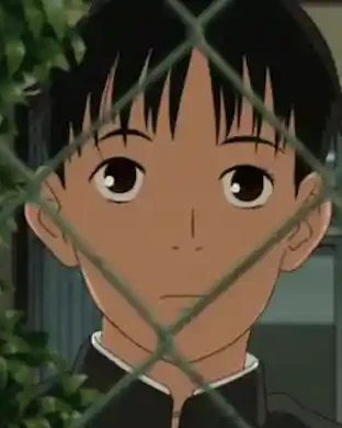 Koyuki looks through a chain-link fence.