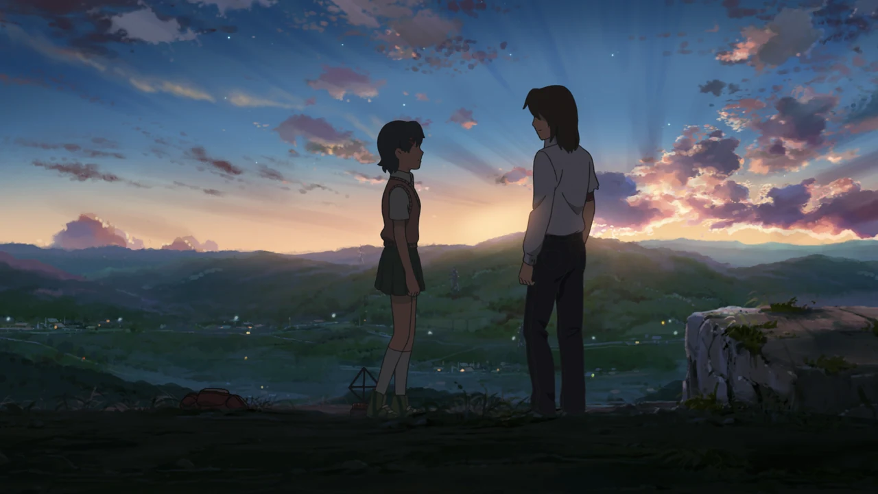 Asuna and a boy face each other on a hillside as sunset lights the clouds behind them.