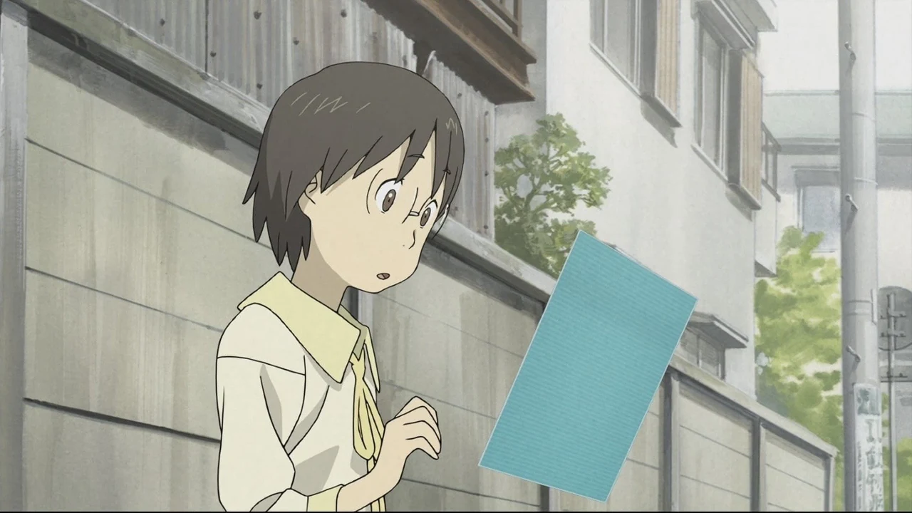 Yasako studies a floating blue display in front of ordinary buildings in Den-noh Coil.