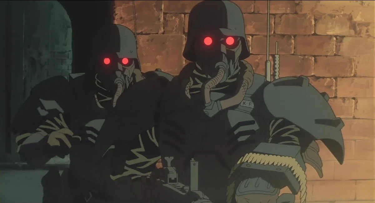 Two armoured police officers wear respirators and glowing red lenses beside a brick wall.