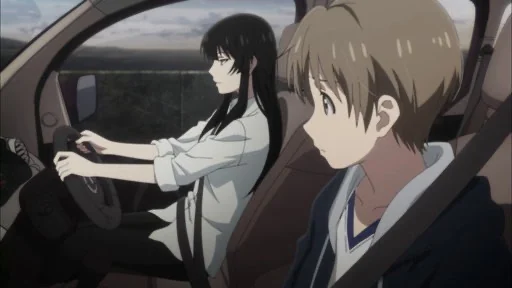 A black-haired woman drives a car while a fair-haired teenage boy looks toward her from the passenger seat.