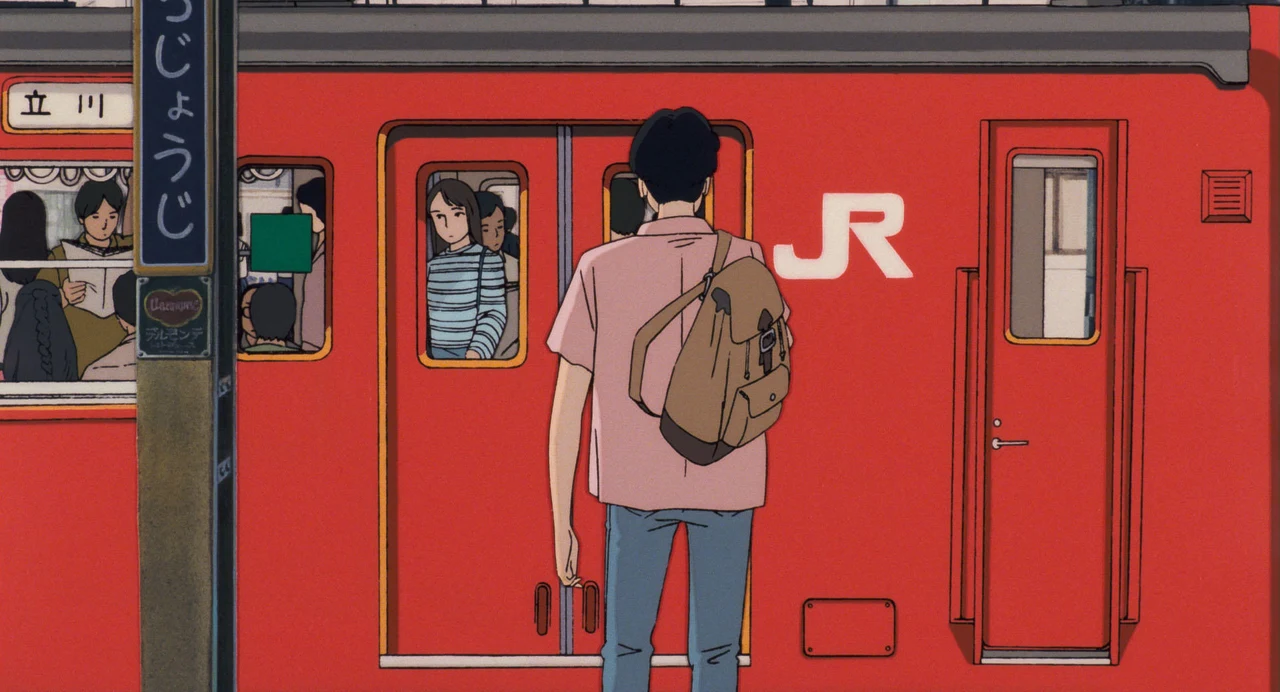 A person stands on a platform outside a red train with another figure behind its window.