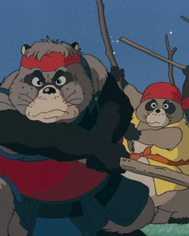 A tanuki leader in red stands before other tanuki carrying poles.