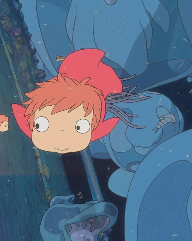 Ponyo swims among small fish in blue water.