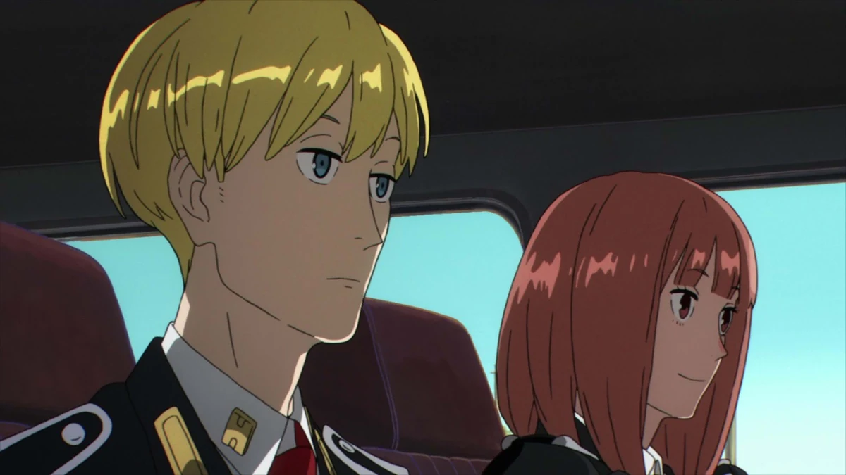 A blond uniformed man and a red-haired woman sit side by side.