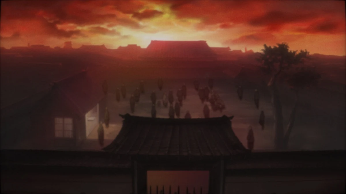 A town’s rooftops and streets lie beneath a red sunset.