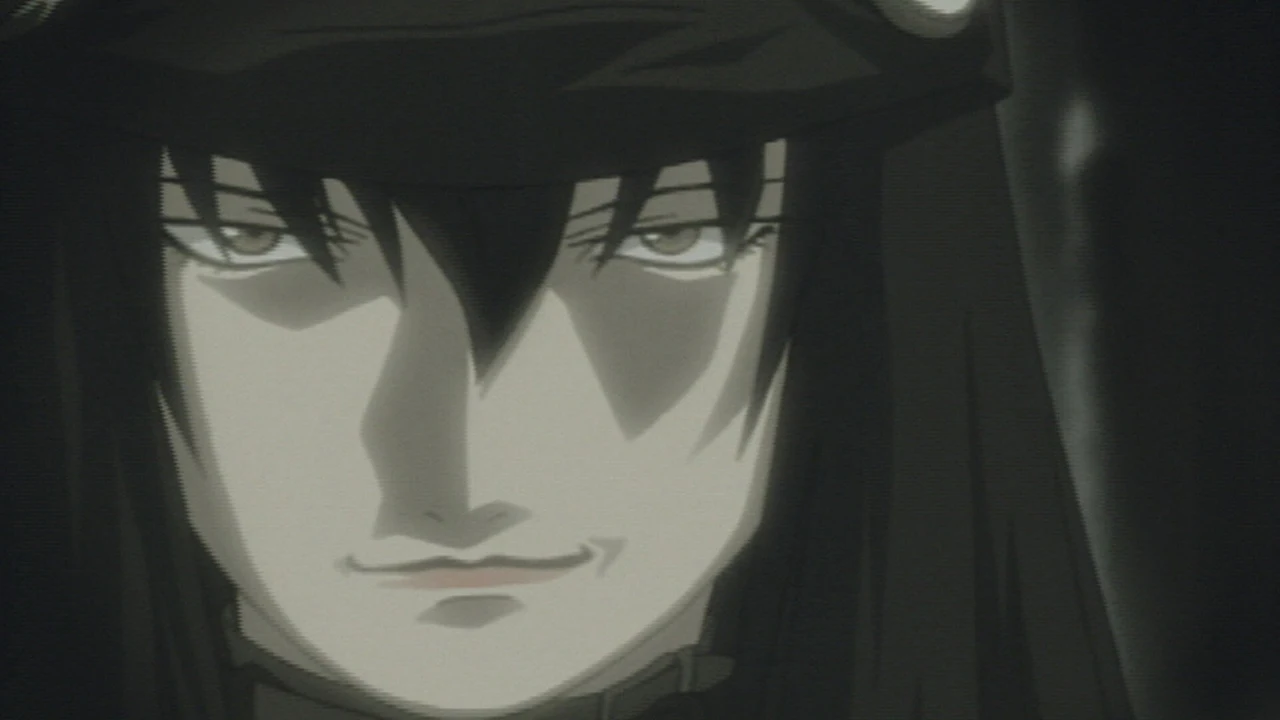 A dark-haired young man looks forward beneath a heavy fringe.