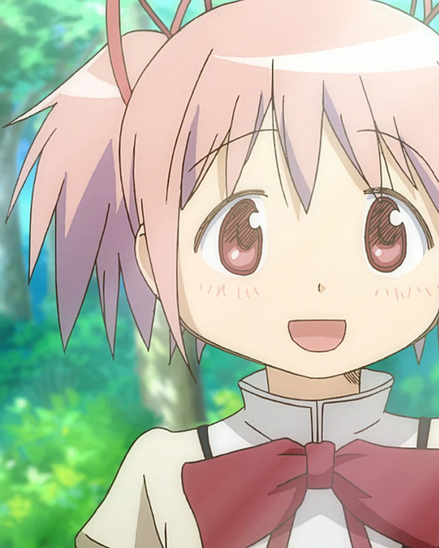 Madoka smiles in her school uniform with green foliage behind her.