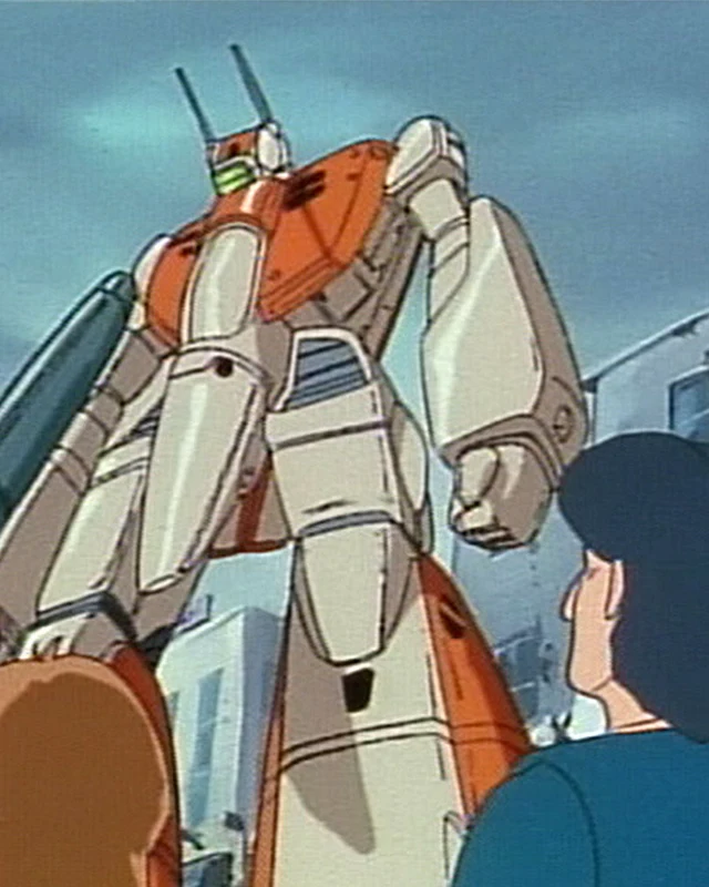 A transforming fighter towers over people in a built-up area.