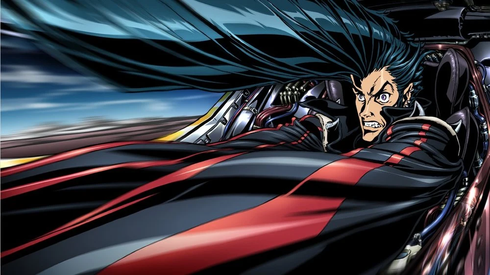 JP leans forward in his cockpit, his hair swept back and his arms stretched across the foreground.