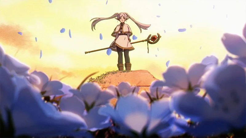 Frieren stands with her staff amid blue flowers in warm golden light.