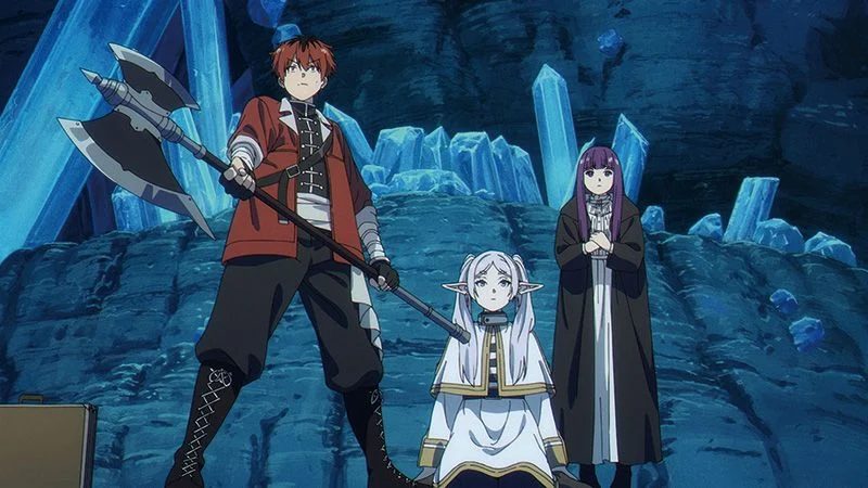 Stark holds his axe at the left, with Frieren seated and Fern standing behind her among blue cave crystals.