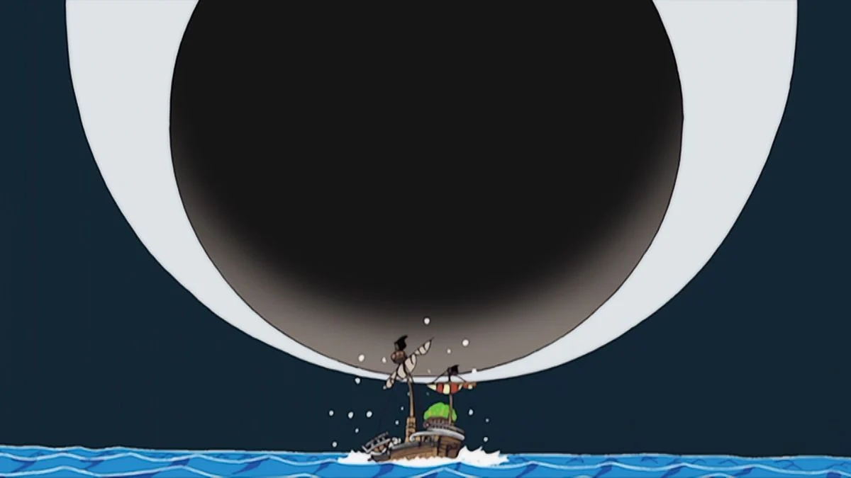 The Going Merry sits on the blue sea beneath the enormous eye of a whale.
