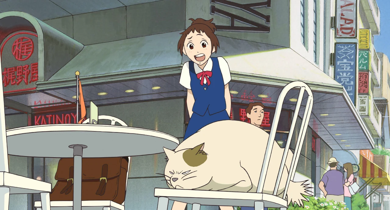 Haru leans towards Muta, a large white cat reclining on a chair outside a street café.