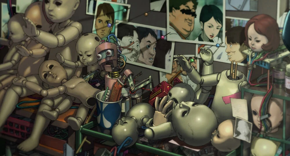 Dolls and toy robots crowd a room beneath pinned photographs of the researchers, several marked or altered.