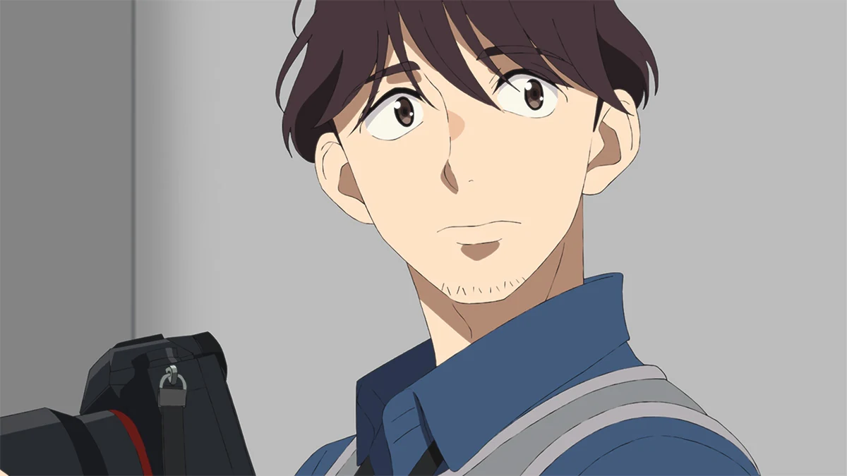 Kouya Madoka with his camera and a shoulder strap at the circuit.