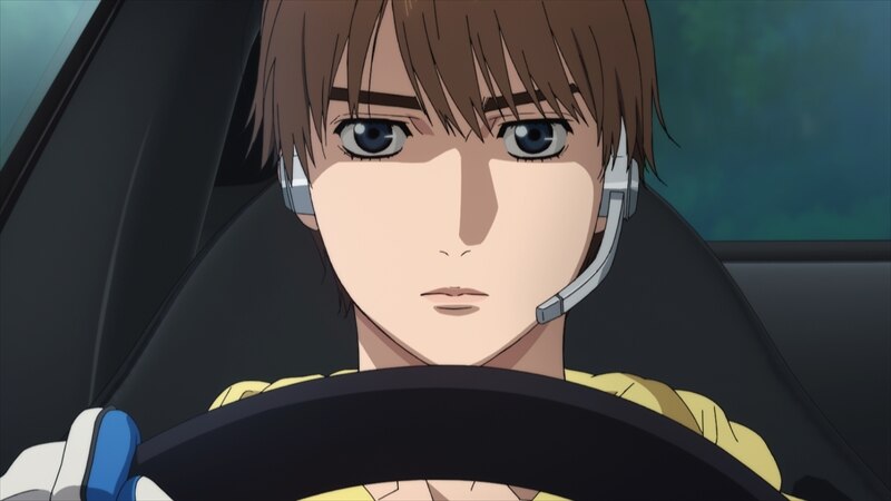 Kanata at the steering wheel wearing a radio headset.