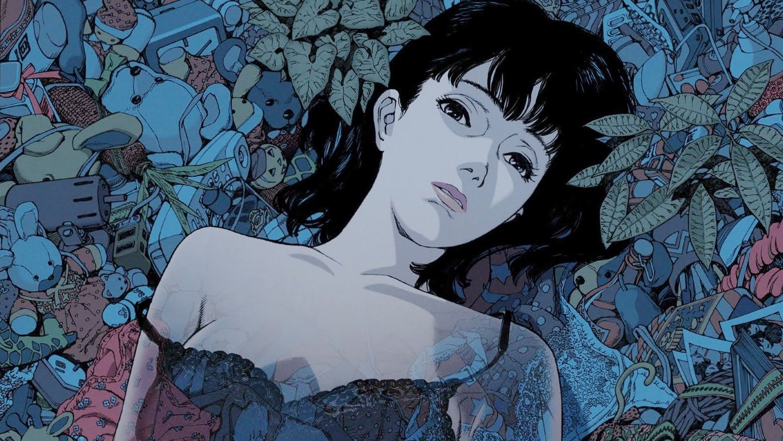 Mima in blue-toned promotional artwork surrounded by toys and objects.
