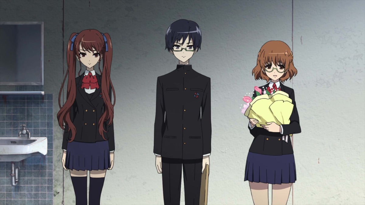 Three pupils stand together in a tiled interior, one holding a bouquet.