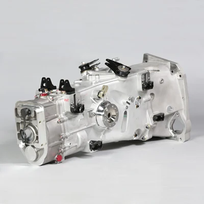 The F110 gearbox shown separately, with its silver casing and mechanical linkages visible.