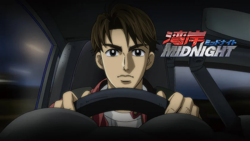 Akio holds the steering wheel at night, beside the Wangan Midnight title logo.