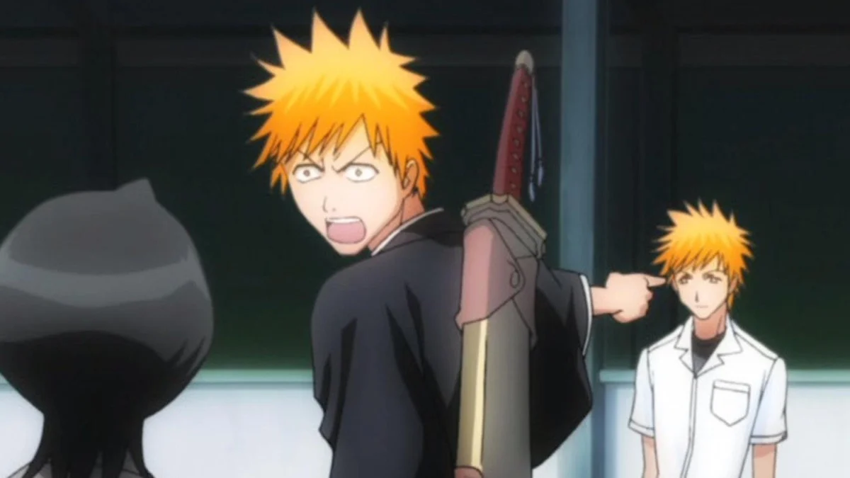 Ichigo in his black Soul Reaper robe points at his school-uniformed double while Rukia looks on.