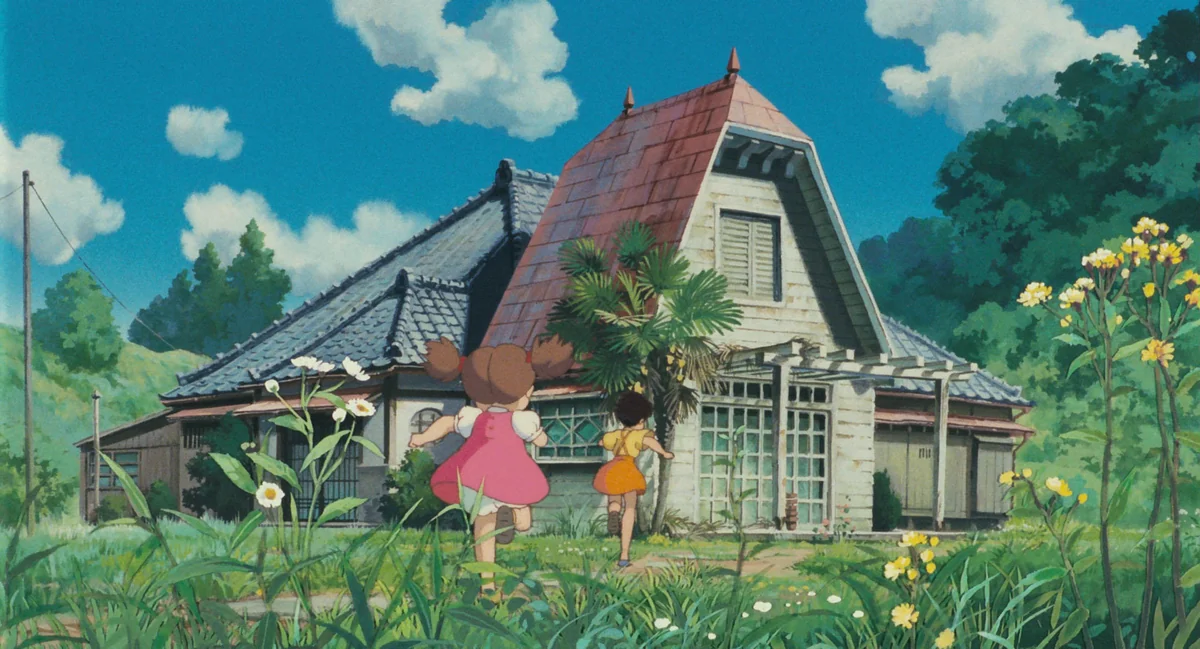 Mei and Satsuki run towards their new country house, surrounded by tall grass and flowers.