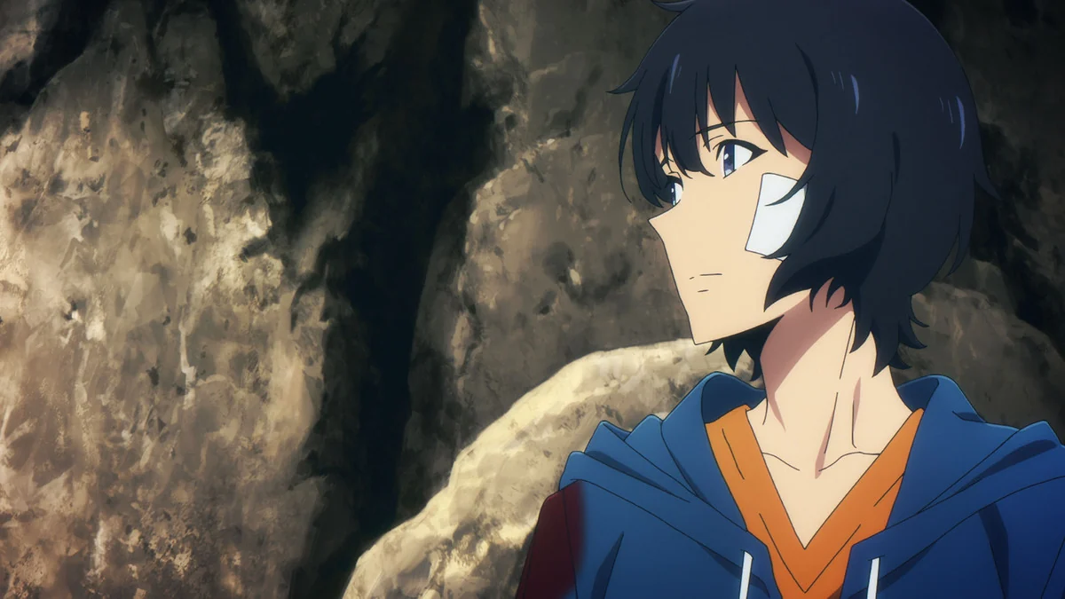 Sung Jinwoo, wearing a blue hoodie and a cheek bandage, looks across a rocky dungeon.