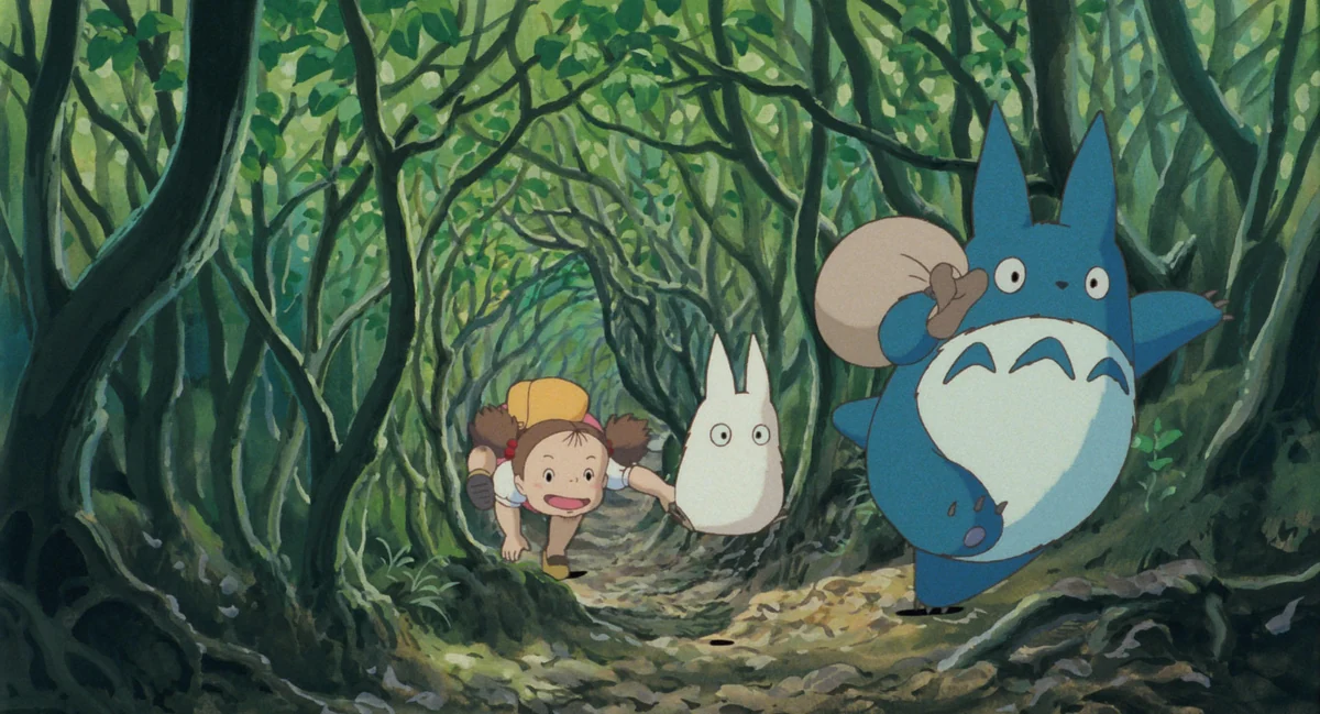Mei follows a small white spirit and a larger blue spirit along a tunnel through the woods.
